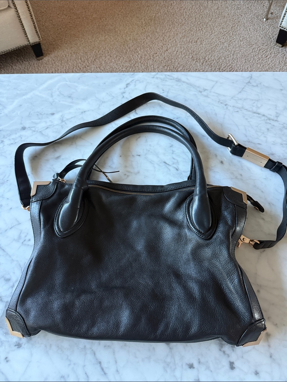 Vintage Foley and Corinna Black leather bag with gold accents.